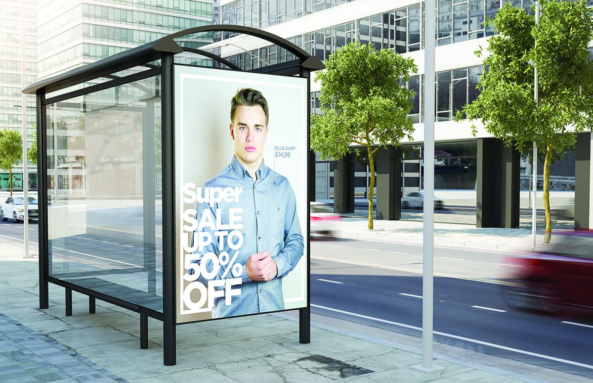 Image of an out-of-home bus station wrap. Man is the focal point and copy on the bus wrap reads 