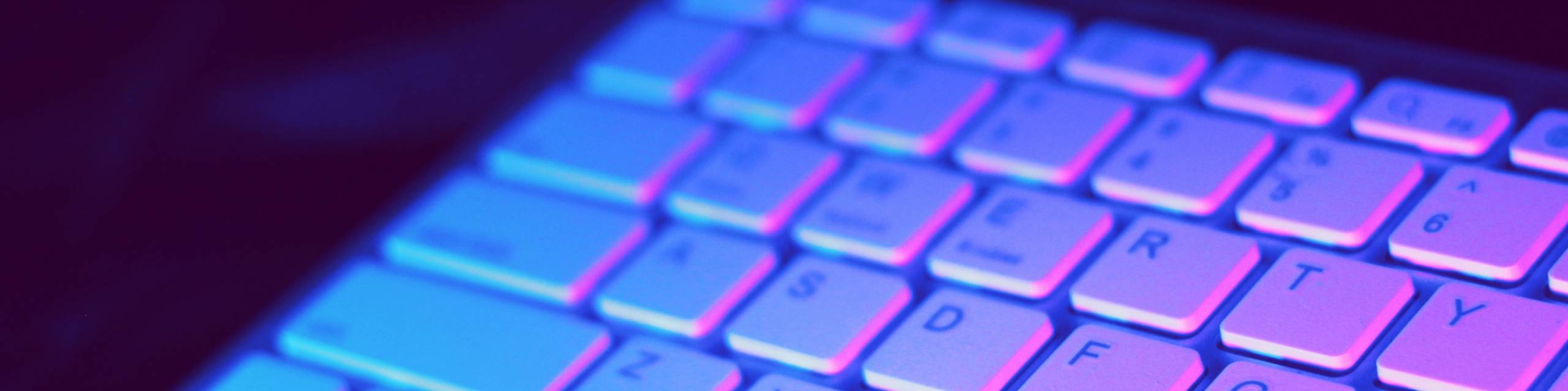 Image of a computer keyboard in dark moody lighting.